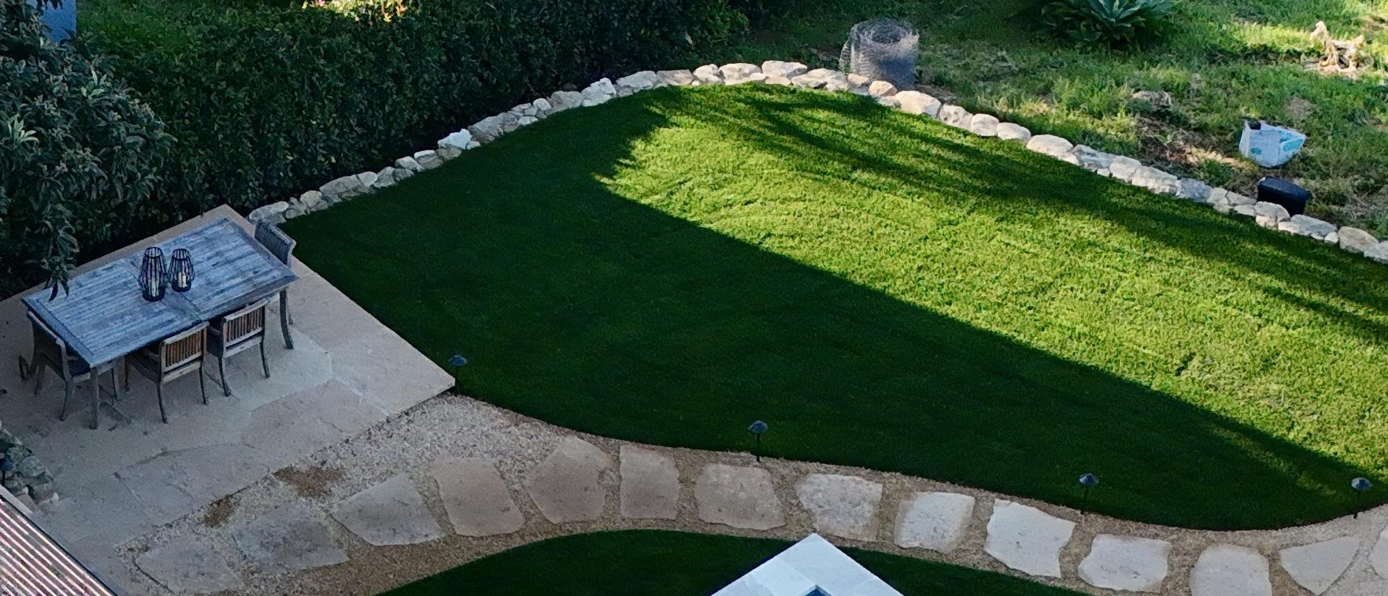 Aerial view of a pool set into a terraced lawn