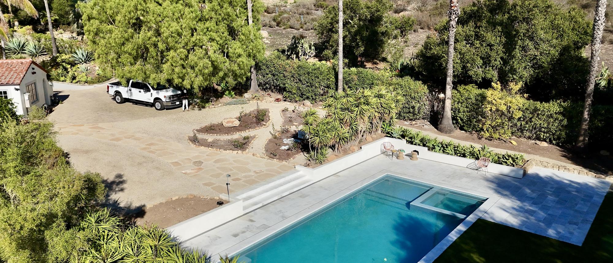 Aerial view of a pool on a hillside property