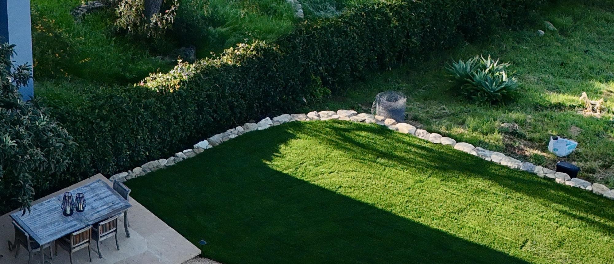 Aerial view of a pool set into a terraced lawn
