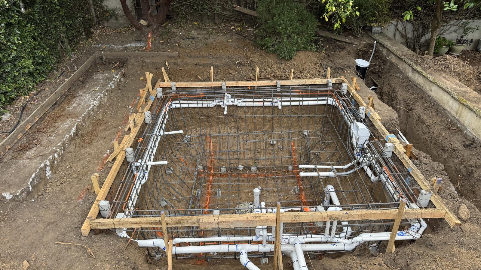 Steel cage and plumbing in place before the shotcrete shoot