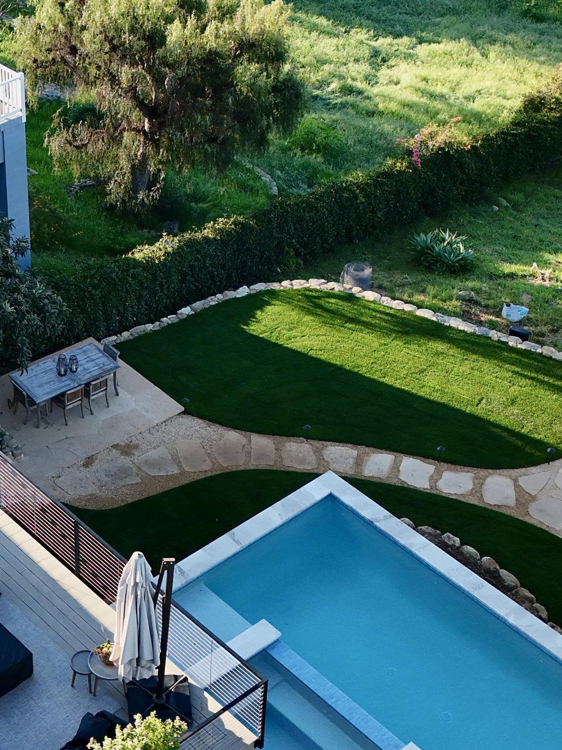 Aerial view of a pool set into a terraced lawn