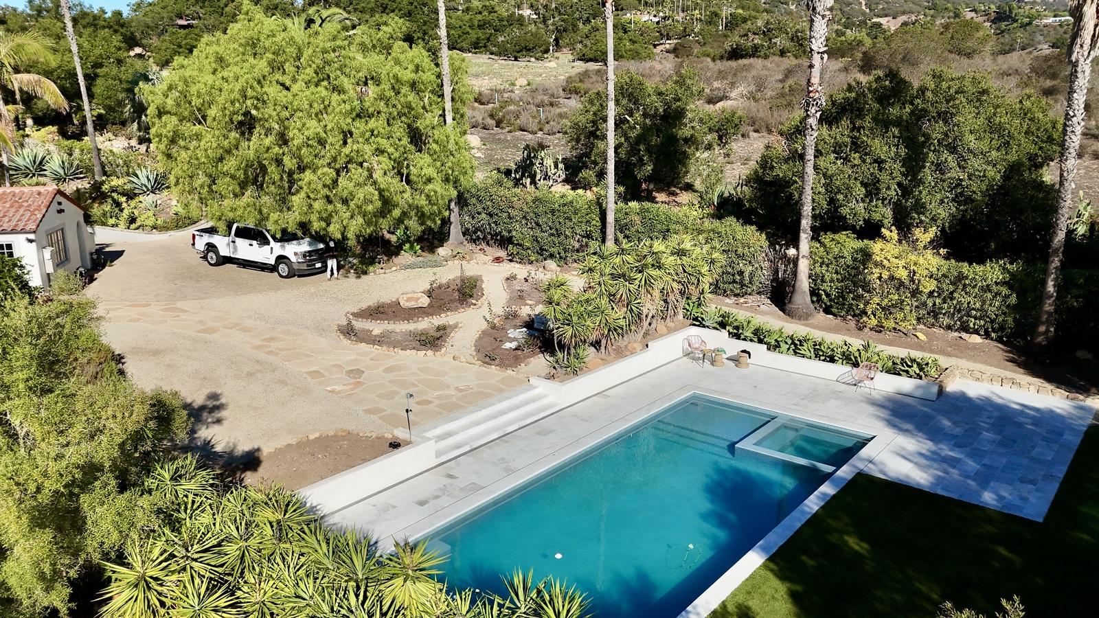 Aerial view of a pool on a hillside property